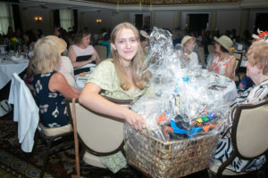 Attendees winning raffles and silent auction items at Sojourner House's fundraiser Victorian Tea