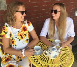 Two young ladies enjoying a cup of tea