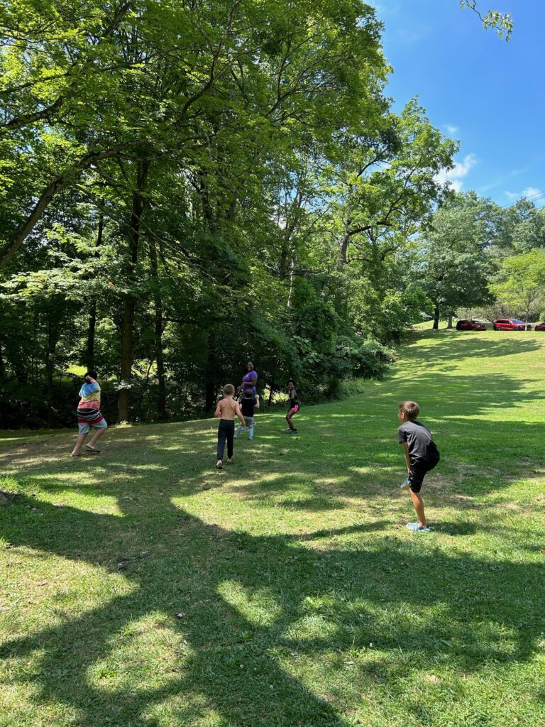 Kids playing with water balloons at the Sista to Sista picnic