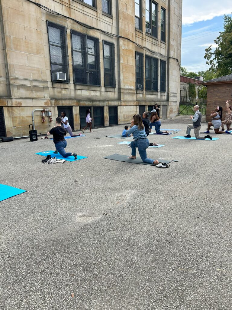 Participants mid-pose at yoga in the streets 2025